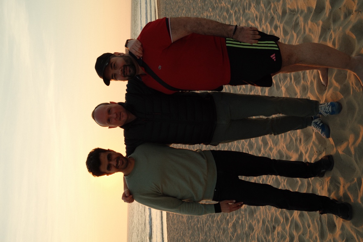 Team members at beach sunset